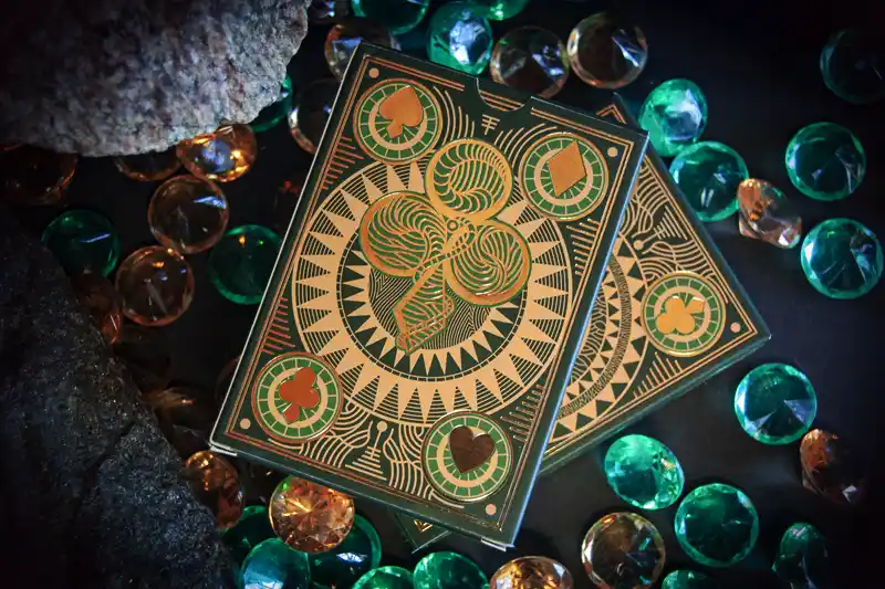 A deck of 55 cards with unique illustrations on the fronts and backs in emerald theme.